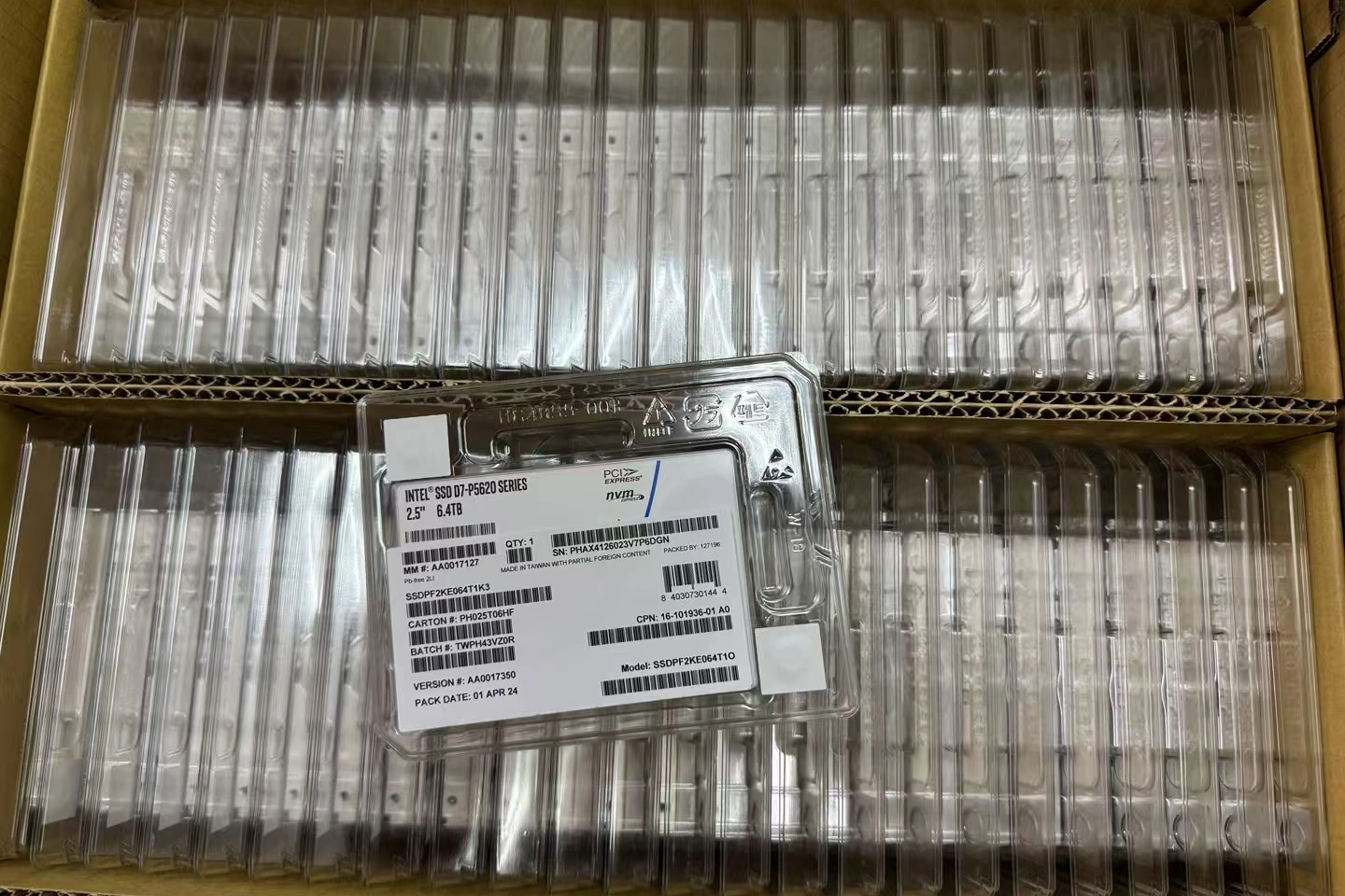 a box containing plastic trays, each labeled with bar codes, organized for ssd storage and identification