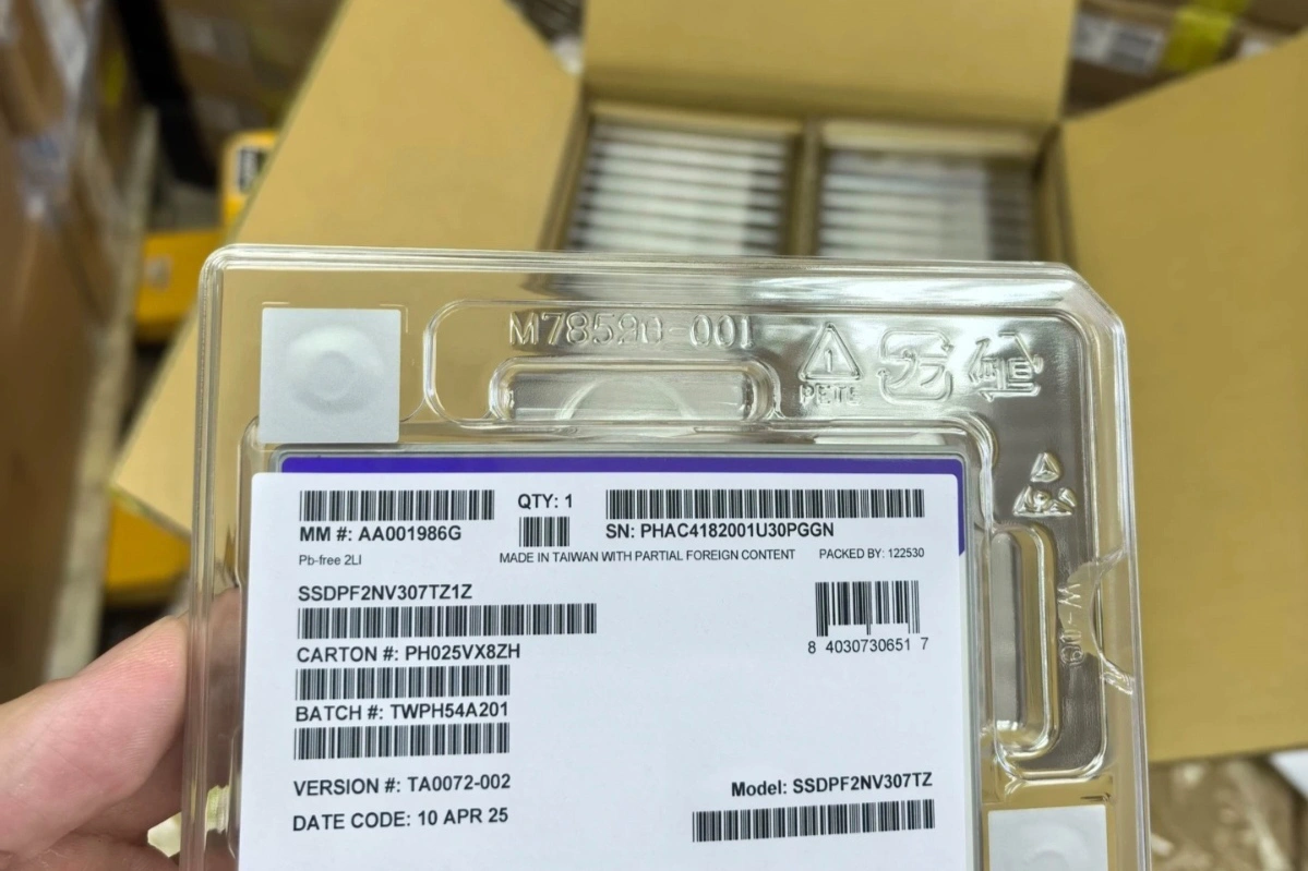 a person holding a package featuring a barcode, indicating it may contain an ssd or related technology