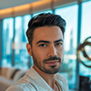 a stylish portrait photograph of a handsome dubai man taking a selfie in a luxurious modern apartment